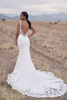 a woman in a wedding dress looking back