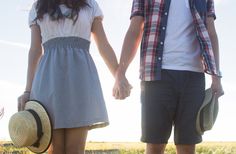 a man and woman holding hands while standing next to each other