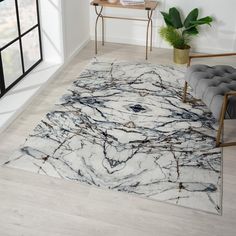 a marbled area rug in a living room with a chair and table next to it