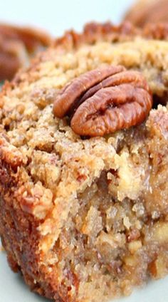 a close up of a piece of food on a plate with pecans in the background