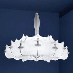 an unusual light fixture hanging from the ceiling in a room with blue walls and flooring