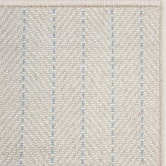 an area rug with blue and white designs on it's edges, in front of a beige background