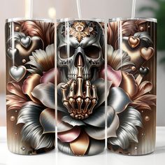 three metal vases with skulls and flowers on them