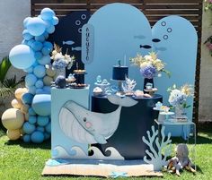 an outdoor party setup with balloons and decorations