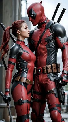 two people dressed as deadpools standing next to each other with swords in their hands