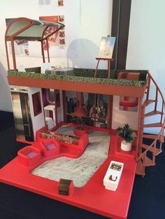 a doll house with furniture and accessories on display