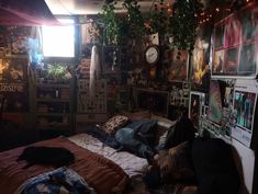 a bed room with a neatly made bed and lots of pictures on the wall