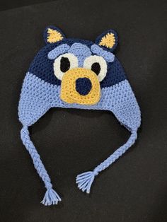 a crocheted hat with a bear face on it