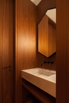 a bathroom with wooden cabinets and a white sink