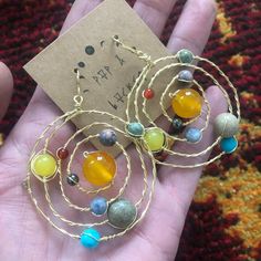 "Solar system celestial earrings are handcrafted from solid copper wire. Earring pendant approx. 2.25-2.5\" in diameter. Hangs from copper fish hook earring approx. 3-3.5\" long. Copper fishhooks are made by hand from solid copper wire which is hypoallergenic, easy to polish and nickel free. Polishing pad included. 💫 yellow Jade/ sun 💫 hematite / mercury 💫 rhodochrosite / Venus 💫 sodalite / earth 💫 jasper / mars 💫 agate/ Jupiter 💫 amazonite / Saturn with copper rings 💫 prehnite / Uranus Artsy Copper Drop Earrings, Adjustable Celestial Wire Wrapped Jewelry, Bronze Wire Wrapped Drop Earrings, Copper Wire Dangle Earrings, Artsy Copper Jewelry With Matching Earrings, Spiritual Copper Drop Earrings, Unique Copper Wire Dangle Jewelry, Unique Dangle Copper Wire Jewelry, Unique Nickel-free Copper Wire Earrings