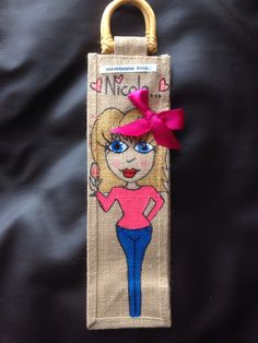 a bag with a cartoon girl on it and a pink bow hanging from the front