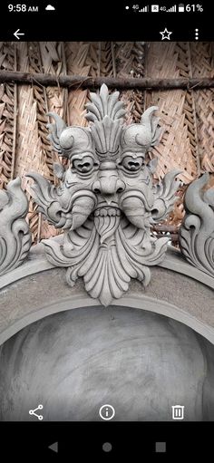 an ornate gargoyle on the side of a building