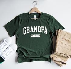 "Grandpa Est.2022. Year can be personalized! More info and how to order below. We are proud to only use top quality fabric to insure softness and durability. All of our items are handmade in the U.S.A. We have been printing shirts since 2016 from our small shop please shop with confidence! PROCESSING TIME: Orders are processed in 1-2 business days. Processing times are always accurately updated and posted and can be found at checkout. Once your order ships out you will receive a tracking number Promoted To Grandpa, Grandparent Pregnancy Announcement, Announcement Pregnancy, 2022 Year, Papa Shirt, Personalized Fathers Day Gifts, Gift For Grandpa, Pregnancy Announcement Shirt