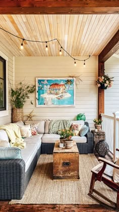 a living room filled with furniture under a wooden ceiling mounted above a white painted wall