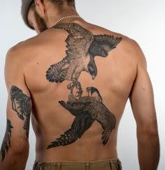 a man with an eagle tattoo on his back