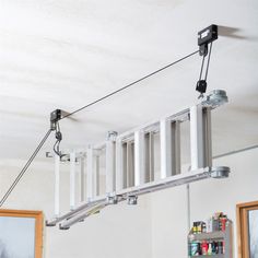 a ladder is suspended from the ceiling by wires