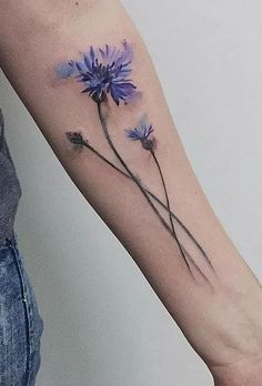 a woman's arm with blue flowers on it