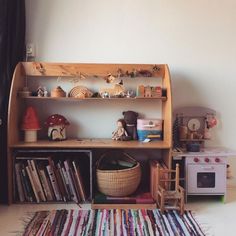 a book shelf filled with lots of books next to a window