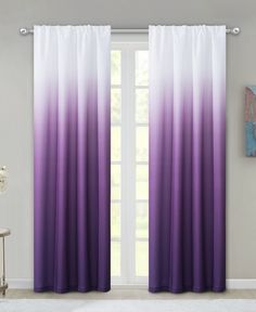 purple and white ombreed curtains hanging in front of a window