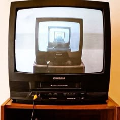 an old television sitting on top of a wooden stand