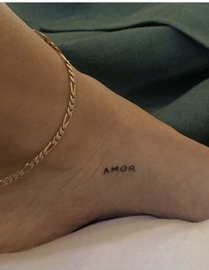 a woman's foot with the word mom tattooed on her left ankle and an inscription below it