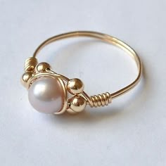 a gold ring with pearls on it