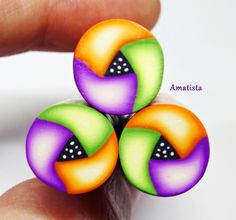 a person is holding three colorful rings in their hand with the words anatasta on it