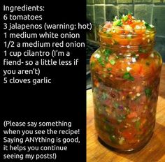 a jar filled with food sitting on top of a wooden table