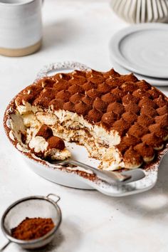 a cake sitting on top of a white table covered in chocolate and cream frosting