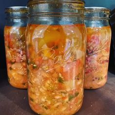 three jars filled with food sitting on top of a table