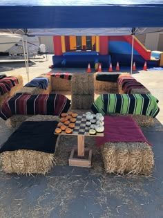 hay bales and cushions on display at an outdoor event