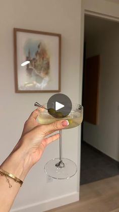 a person holding a wine glass in their hand