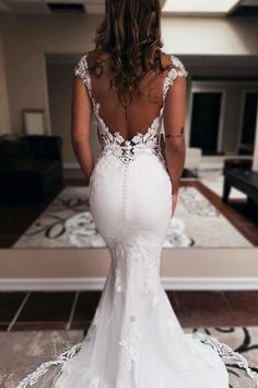 a woman in a white wedding dress looking back