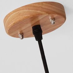 a close up of a wooden light fixture with two wires attached to the side of it