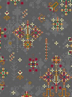 a gray background with many different colored designs on the fabric, including flowers and crosses