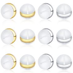 a set of white and gold buttons on a white background with some reflection in the middle