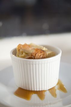 a white bowl filled with food on top of a plate