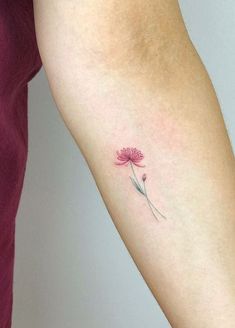 a small pink flower on the left arm