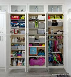 an organized closet with white shelves and bins filled with items, including plastic containers