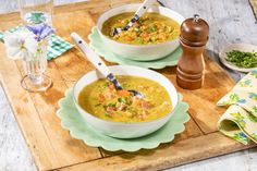 two bowls of soup on a wooden table