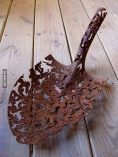 an old rusty umbrella sitting on top of a wooden floor