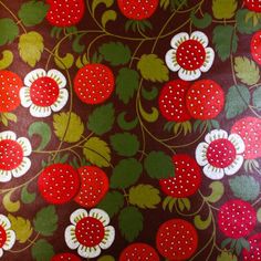 a red and green wallpaper with strawberries on the bottom, white dots in the middle