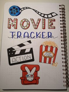 an open notebook with the words movie trackerr written on it