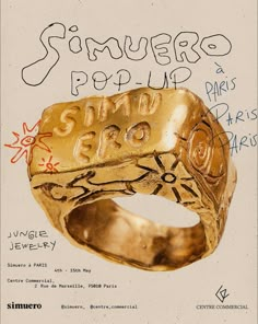 a gold signet ring with the words san francisco pop up written in spanish on it