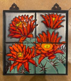 a tile with flowers painted on it