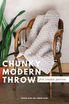 a chair with a crocheted blanket sitting on top of it next to a potted plant