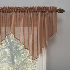 the curtain is hanging in front of the window