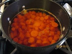 carrots are being cooked in a pot on the stove