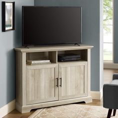 a flat screen tv sitting on top of a wooden cabinet