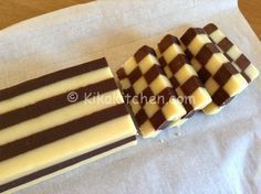 four pieces of chocolate sitting on top of a white table cloth next to each other